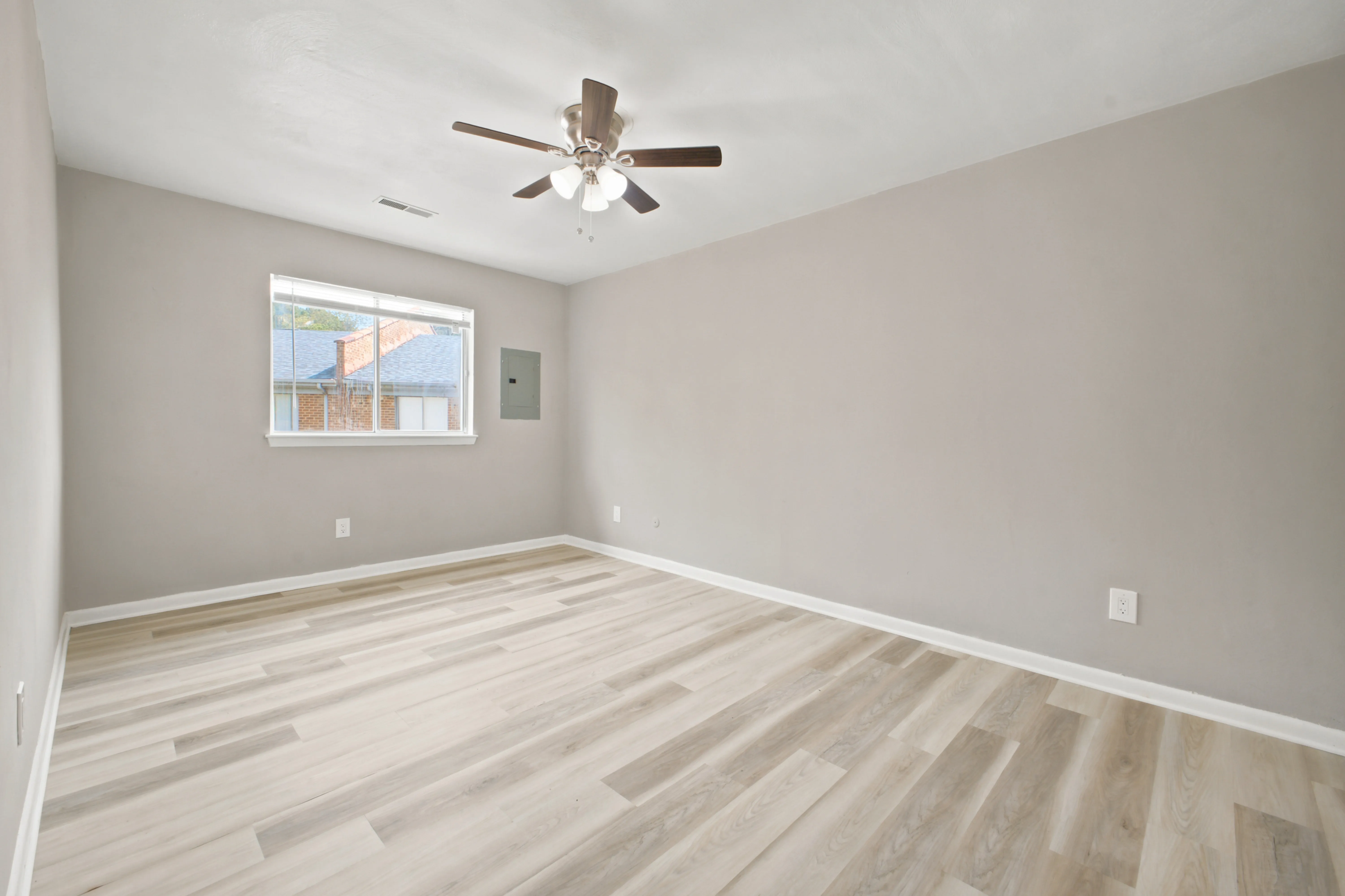Second bedroom with a window and ceiling fan